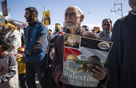 An old man walk with a placard during a rally marking Quds Day. Thousands of people rallied in Kashmir to express solidarity with Palestine, Lebanon, and Yemen as part of Al-Quds Day. Al-Quds Day, an initiative introduced by the late Iranian revolutionary leader Ayatollah Ruhollah Khomeini, is observed globally on the last Friday of the holy month of Ramadan to show support for Palestinians and condemn Israel.