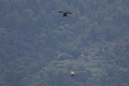 A drone carrying food and essential supplies flies over flood-affected areas as rescue and relief efforts continue following devastating flash floods and mudslides at Devighat in Bidur Municipality, Nuwakot district. The disaster, triggered by a glacial collapse and massive debris flow upstream, devastated communities along the Trishuli River, leaving hundreds dead and many others missing.
