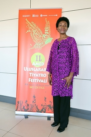 Jessica Kaahwa, President of the International Theatre Institute, is seen in front of the banner for the 11th Amed International Theatre Festival. Jessica Kaahwa, President of the International Theatre Institute (ITI), attended the 11th Amed International Theatre Festival, organized by the Diyarbakir Metropolitan Municipality and the Amed City Theatre in the city of Diyarbakir.