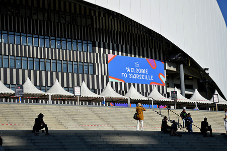 People and Rugby World Cup posters are seen at the entrance to the Orange-Velodrome Stadium. France hosts the 2023 Rugby World Cup from September 8 to October 28, 2023. The South Africa - Tonga match will take place at the Orange-Vélodrome stadium in Marseille on October 1, 2023.