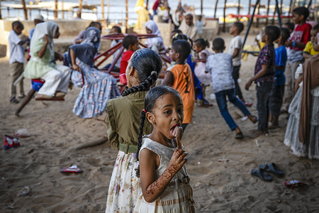 Children enjoy a playground on Shela Island off the coast of the Indian Ocean in Kenya. Shela is one of several islands in Lamu County. This area boasts some of the oldest and most well-preserved Swahili cultural settlements in East Africa. There are no cars on Shela and the town's calendar and daily schedule largely revolves around Islamic religion and culture.
