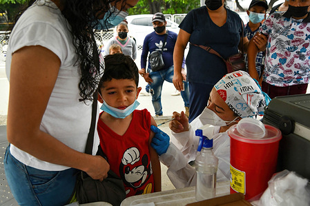 A health worker administers a dose of COVID-19 vaccine to a child in the neighborhood of La Parada, near the Colombia-Venezuela border. 502 Colombian communities in the country already have more than 70% of their population with a complete vaccination schedule against covid-19, and lifted the measure of the use of face masks in open spaces.