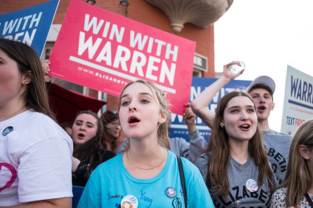 Protesters shout slogans while holding placards during the democratic debate in support of Elizabeth Warren in Westerville.