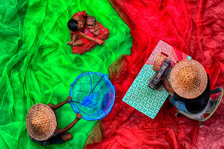 Fishermen were seen stitching colourful fishing nets during the pre-fishing session. In the Indian Sundarbans, particularly along the western banks of the Matla River, rising sea levels and rapid coastal erosion are forcing fishermen and wildlife into shrinking territory. The sea level has increased by 3–5 centimeters annually over the past two decades, making it one of the fastest-eroding coastal regions globally. As land disappears, both humans and endangered Bengal tigers are being pushed into closer, often dangerous, proximity.