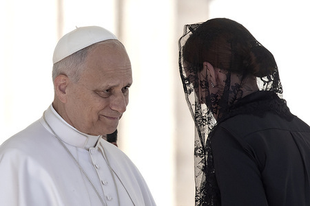 Pope Leo XIV greets a faithful during his weekly general audience in St. Peter's Square at the Vatican.