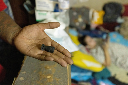 Resident of Din Daeng flat is seen showing a rubber bullet fired by the riot police during the demonstration.Pro-democracy protesters gathered at Din Daeng intersection to demand the resignation of Prayut Chan-O-Cha.