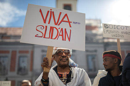A demonstrator holds a placard during a demonstration. Sudanese residents gathered at the Puerta del Sol to denounce the abuses suffered by their country at the hands of the United Arab Emirates, with President Mohammed bin Zayed Al Nahyan being held primarily responsible, and his interest in illegal gold mining. They also denounced the abuses committed by the Rapid Support Forces (RSF), including murders and rapes against the population.