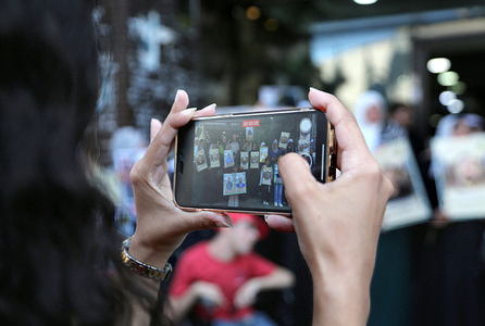 A young Palestinian woman takes a photo with her mobile phone during the commemoration of the 40th anniversary of the Sabra and Shatila massacre, which occurred in 1982 in camps in southern Lebanon. A commemorative rally was held in Nablus, Palestine, coinciding with the 40th anniversary of the 1982 Sabra and Shatila massacre. Participants honored the memory of the victims killed during the historic September 1982 assault on the Palestinian refugee camps located in West Beirut, Lebanon.