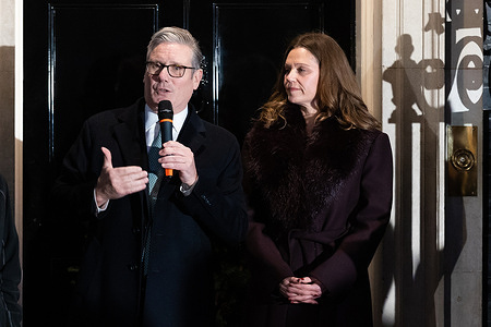 British Prime Minister Keir Starmer and his wife Victoria Starmer watch litter-picking volunteer Samuel Salamone switch on the Downing Street Christmas tree lights in London, UK on 1st December 2025.