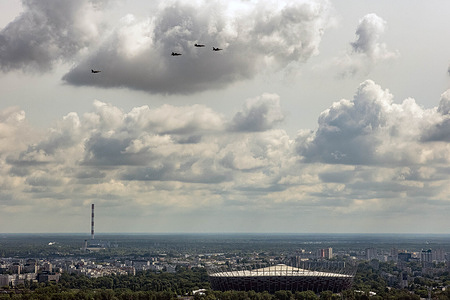 The F-35 jets fly along the Vistula river, past the National Stadium. Two F-35 "Husarz" fighter jets fly over the city of Warsaw escorted by F-16s. As part of the "Welcome to Poland" for the new line of fighter planes, the F-35s are the first to fly in Poland during a ceremonial flyover. The jets were delivered to the Polish Air Force in May as part of a 4.6 Billion dollar deal. The Jets travel the length of the country passing through Gdansk, Warsaw, and Krakow.