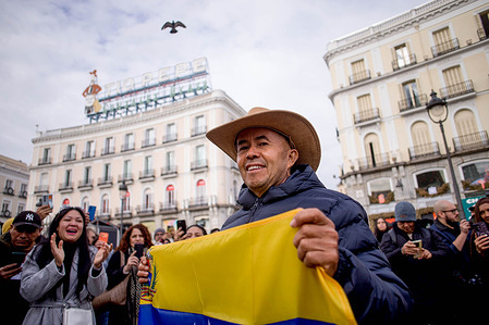 A Venezuelan living in Madrid dances while holding a Venezuelan flag, during a celebration in downtown Madrid, after US President Donald Trump announced that Venezuelan President Nicolas Maduro had been captured and expelled from the country.