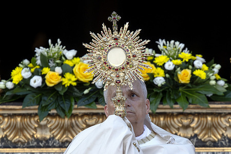 Pope Leo XIV holds up the monstrance in front of St. Mary Major Basilica after the Corpus Christi procession from St. John Lateran Basilica.
