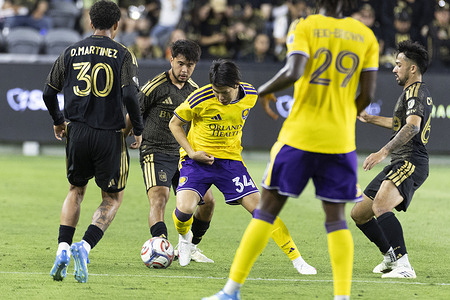 Orlando City’s Yutaro Tsukada (34) and Los Angeles FC’s Ryan Raposo (21) vie for the ball during an MLS soccer match at BMO Stadium. Los Angeles FC 6:0 Orlando City SC.