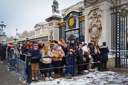 Visitors are seen outside Buckingham Palace to observe the Changing of the Guards ceremony. London is blanketed with snow, as the Met office issues yellow weather warnings for freezing temperatures.