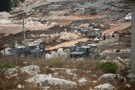 Military vehicles and Israeli soldiers guard Israeli bulldozers as they demolish a Palestinian home in Area C. The demolition of Palestinian homes has escalated as part of Israel's efforts to seize land in the West Bank, which is under Palestinian control according to the Oslo Accords between the Palestinians and Israelis.