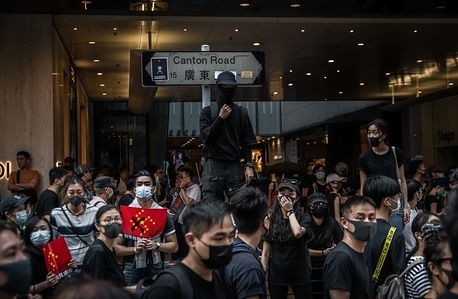 Protesters wearing masks gather at Canton Road during the anti-government march.
Protesters defy demonstration ban, anti-mask law in Hong Kong and continue to protest across Hong Kong for the 20th consecutive week. After marching for few hours from Tsim Sha Tsui towards the speed train rail station, clashes between protesters and riot police occurred in different parts of Kowloon side.