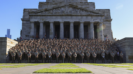 The 4th Battalion, Royal Australian Regiment seen standing for a group photo on the steps of the Shrine of Remembrance. Thousands attended the ANZAC Day march in Melbourne, as veterans, current service personnel, community groups and local leaders marched through the city in commemoration of Australian and New Zealand service members.
