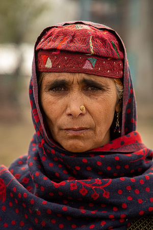 A Kashmiri nomadic woman poses for a photo on a cold autumn day at a village in Kulgam district about 60kms, south of Srinagar.