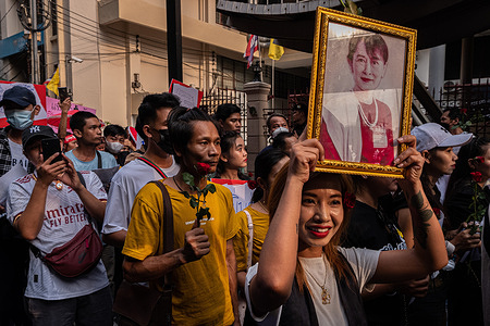 A Myanmar worker holds a portrait of Aung San Suu Kyi during the march to mark the international labor day. Thai and Myanmar workers marched together in the center of Bangkok to mark the International Labour Day and calling for the workers rights and protest against the Myanmar military government.