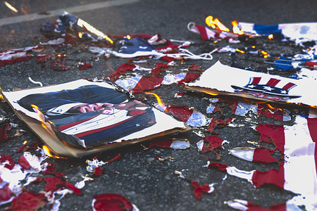Burned remains of a U.S. flag, an Israeli flag and a torn caricature of former U.S. President Donald Trump are seen on the ground. Political, trade union and social organizations held a demonstration outside the U.S. diplomatic mission in Buenos Aires’Palermo district on protesting what they described as United States interference in Venezuela. The protest was part of a broader call to reject foreign intervention and express solidarity with the Venezuelan government and people, organizers said.