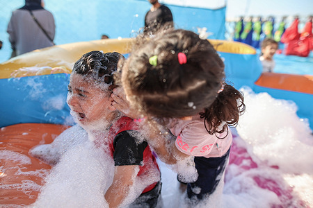 Palestinian children play at the "Water City" in the Gaza Strip. "Water City" is the first water games playground in the Gaza Strip founded by businesswoman Hiba al-Hindi. Palestinians suffer from a lack of entertainment venues due to the Israeli blockade and the difficult economic and political conditions experienced by the residents of the Gaza Strip.