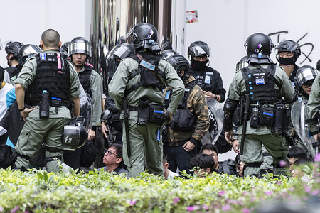 A group of protesters being detained outside a shopping mall during the demonstration.
Sunday march in Sheung Shui against parallel trading, they demand for the authorities to take action against parallel traders who stock goods in local shops then turn around selling them for profit across the border. More of these marches have seen since Hong Kong protests started in June and often resemble anti-government rallies.
