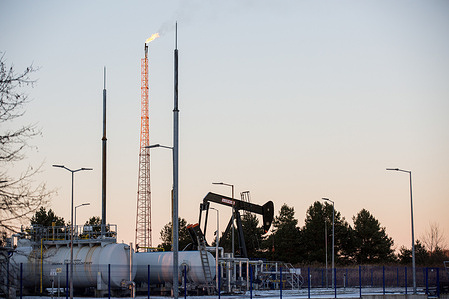 General view of an oil extraction area with Lufkin Industries pump unit located in Lakie, Lubusz Voivodeship. The flare was caused by burning off natural gas produced along with the oil. PGNiG (Poland's national oil and gas company) will spend 10.8 billion PLN on new investment in 2022 as they plan to produce 0.677 million tones of oil.