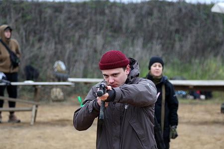 A civilian is seen during the general physical training at a training ground. The 12th AZOV Brigade organized a training session for civilians at a training ground in the Odessa region. During the training, students learned how to use firearms, learned about mines, and took part in general physical training.