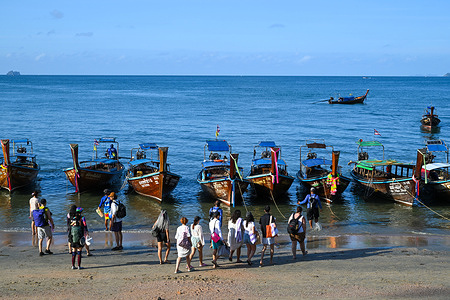 Tourists head out from Ao Nang Beach in Krabi, Thailand, for island hopping to popular destinations such as the Phi Phi Islands, Hong Islands, Bamboo Island, Chicken Island, and Poda Island by long-tail boat.