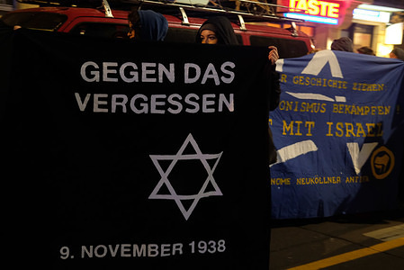 Woman seen holding a banner during the demonstration in support of the victims of antisemitism.
About 100 demonstrators take part in the demonstration for the victims of antisemitism in the anniversary of the fall of the Berlin wall.