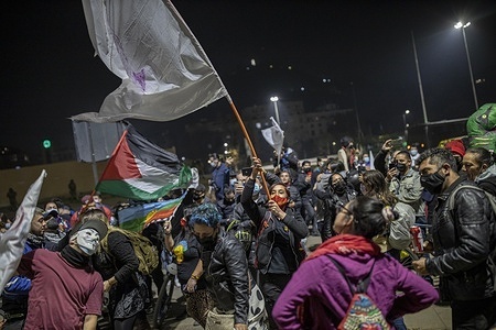 A woman waves a flag during the celebration.
After two days of electoral voting in Chile, where the low flow of people characterized the democratic process, members of the Communist Party of Chile gather in the vicinity of Plaza Baquedano to celebrate the triumph of the candidates elected as constituents, the election of constituents has been a historic process in the country.