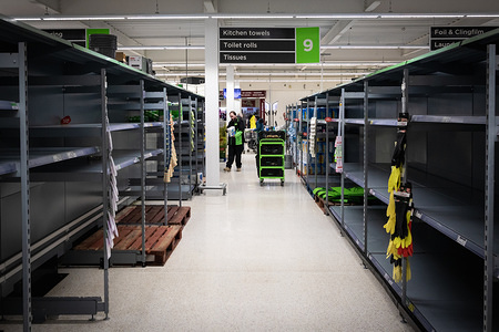 Toilet roll shelves left empty as an employee tries to replenish with the few rolls left in the store during the corona pandemic.
Despite advice from the government to be responsible when shopping and think of others, people were queuing an hour before opening time at Costco, Trafford Park.