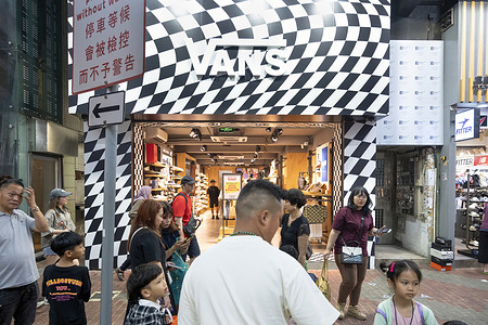 Pedestrians and shoppers are seen outside the American multinational sports clothing brand owned by VF Corporation, Vans, store in Hong Kong.