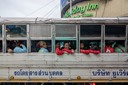 A bus seen filled with people during rush hour traffic in Bangkok.