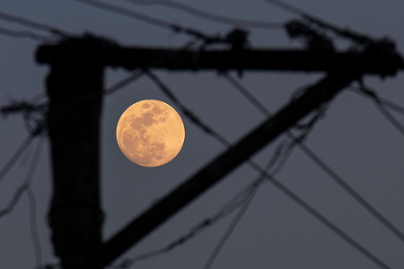 A full moon rises in the night sky over Srinagar. The full moon, commonly known as the Worm Moon in March, marks the final full moon of the winter season in the Northern Hemisphere.