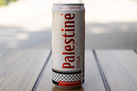 In this photo illustration, a can of Palestine Cola soft drink is seen on a table. Safad Food AB, the parent company of Palestine Drinks, donates 100% of its profits to humanitarian efforts in Palestine. The company is engaged in social initiatives focusing on sustainability and community support through the sale of its beverages.