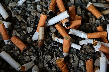 Several cigarettes seen in a concrete ashtray at the Alpe d'Huez ski resort.