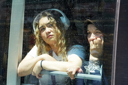 Two women look through the tramway window in the center of Istanbul.