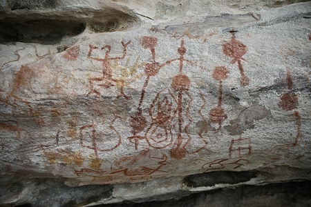 A painting on a rock face in the Monte-Alegre State Park depicts symbols and zoomorphic creatures. Monte Alegre State Park, in Pará, Brazil, holds one of the Amazon basin's largest and most ancient rock art collections. Some pigment-based paintings date back 12,000 years, according to some archaeologists. The site is one of the oldest human-occupied sites in the Americas.