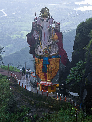 Tourists are seen standing below an idol of an elephant-headed Hindu god Ganesha standing on the cliff of a hill at Matheran, a hill station in Raigad district on the outskirts of Mumbai. A majestic idol of elephant-headed Hindu god Ganesha is carved out of a single boulder which stands atop a cliff. It is known as 'Kadyavarcha Ganpati', (Ganesha on a cliff of a hill) in local language. It is very popular amongst tourists who visit Matheran hill station throughout the year which is known to be partial automobile free, eco-sensitive region with plenty of natural beauty surrounding it.