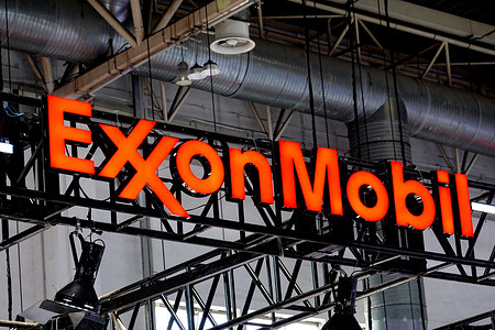 A close - up of the illuminated red “ExxonMobil” logo hanging from the ceiling at the 3rd China International Supply Chain Expo. The bright signage stands out against the industrial background, representing ExxonMobil's brand in the global energy supply chain. The third edition of CISCE has brought together more than 650 companies and institutions from 75 countries and regions said the China Council for the Promotion of International Trade the organizer of the expo.