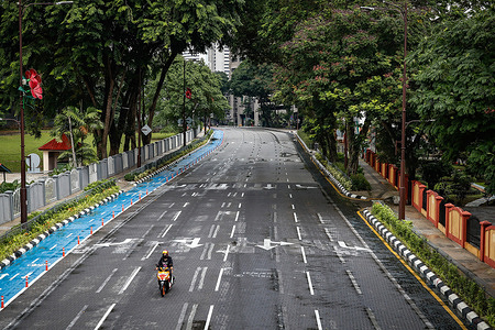 A motorcyclist is seen riding along an empty street in downtown Kuala Lumpur.
Malaysia government starts to further tighten the movement control and imposes lockdown in state of Selangor and parts of Kuala Lumpur, due to the daily high number of coronavirus cases reported.