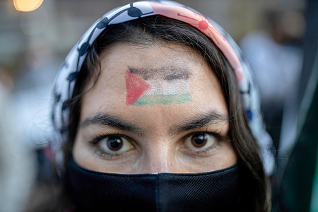 A woman is seen with a Palestinian flag painted on her face during the rally.Palestinians residing in Chile carry out a peaceful rally outside the Israeli Embassy in support of the Palestinian people following the Israeli-Palestinian violence recently.