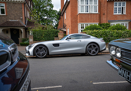 A silver Mercedes AMG GT Coupe c190 seen parked on a London suburban street. The Southside Hustle Car Meet is held on Wimbledon Common in Southwest London every first Sunday of the month. This free community event attracts owners of classic cars, supercars, sports cars, and rare or modified vehicles. Car enthusiasts, photographers, and families gather to admire an impressive variety of cars, meet like-minded people, and enjoy the welcoming atmosphere in the scenic surroundings of Wimbledon Common.