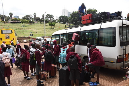 Students of Moi High School Kabarak load a mini bus with suitcases at Uhuru Park in Nairobi as they wait to be ferried to their homes following an order by the Kenyan government to suspend learning in all educational institutions as a preventive measure against the spread of Coronavirus. Kenya has since reported four cases of the COVID-19.