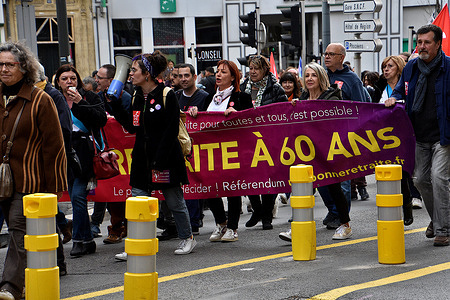 Protesters hold a banner while chanting slogans during the demonstration. Thousands of people marched on the streets of Marseille and all over France to protest against the pension reform proposed by the French government which would raise the retirement age from 62 to 64 years.