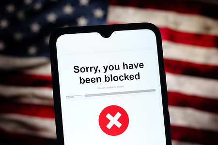 In this photo illustration, the message "Sorry you have been blocked" is seen displayed on a smartphone screen.