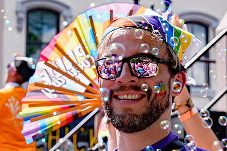 A man marches during the WorldPride Parade. WorldPride 2025 faced challenges due to President Trump's anti-trans policies which included boycotts from some countries.