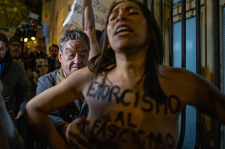 (EDITOR'S NOTE: Image contains nudity) 
A man harasses a Femen activist during the demonstration at the entrance of the Parish of the Twelve Apostles in Madrid where a mass was held organized by the family of the dictator Francisco Franco and the Francisco Franco National Foundation as a commemoration of the 50th anniversary of his death.