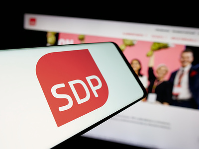 In this photo illustration, a smartphone with the logo of Suomen Sosialidemokraattinen Puolue (SDP) is seen on screen in front of website.